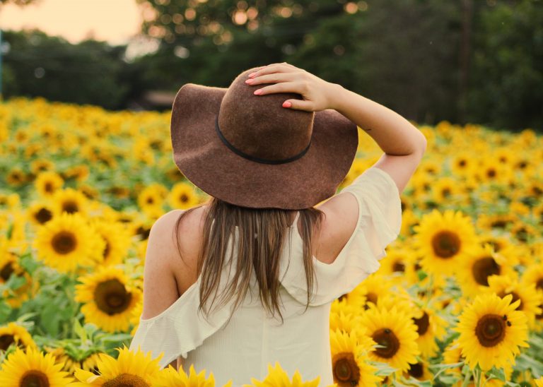 photo-of-woman-in-a-sunflower-field-906002-768x548